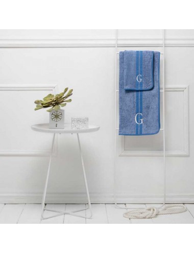 A pair of customizable blue terry cloth towels with white waffle weave edge