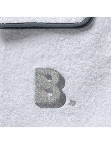 Pair of white terry cloth towels with three-dimensional initial