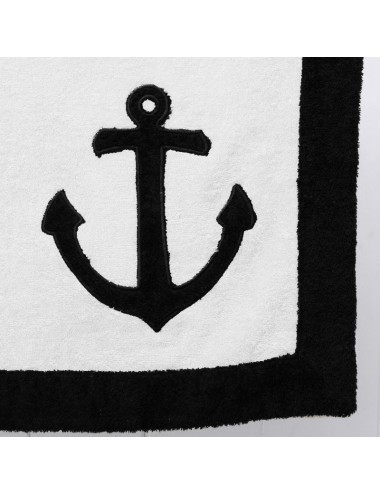 Sand-colored terry cloth beach towel with black terry cloth edge and a sea anchor patchwork embroidery