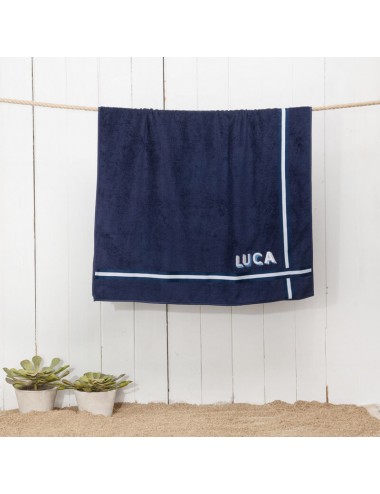 Terry cloth beach towel with three-dimensional initials and trimmings